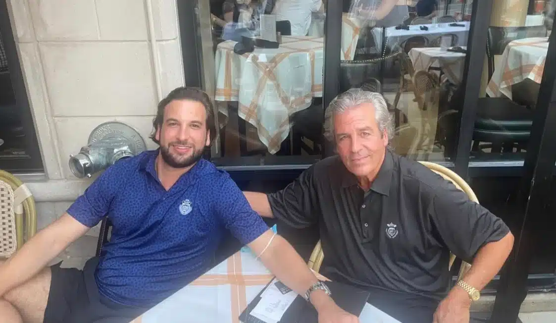 Taylor and John Rijos sit outside at a cafe