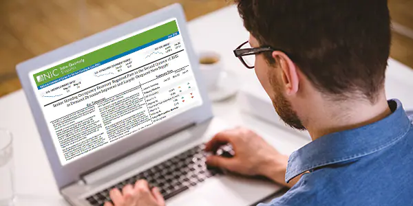 A reader views the NIC Intra-Quarterly Snapshot document on their laptop